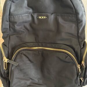 Tumi Black Backpack with Adjustable Straps and Gold Hardware